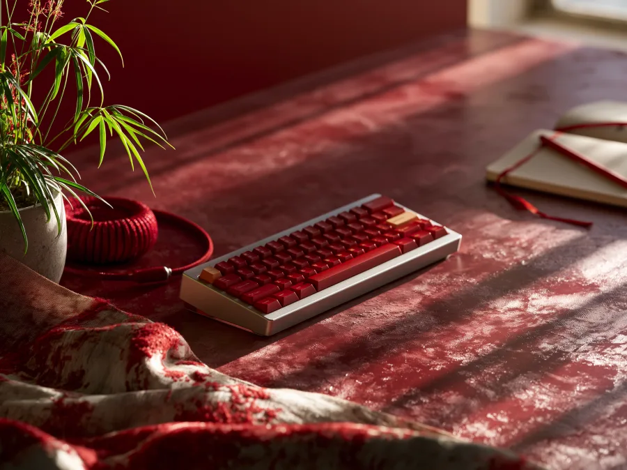 A red mechanical keyboard on a developer's workspace